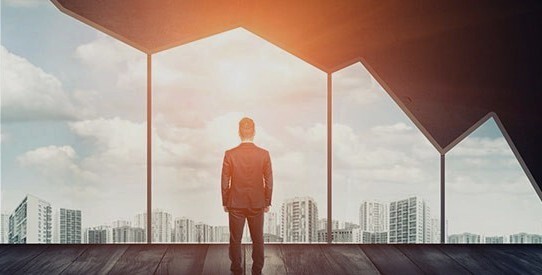 Businessman looking out graph shaped window