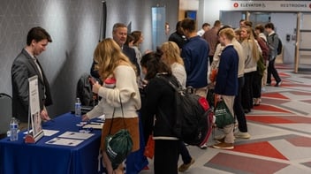 Students gathering at Foundation event to speak with sponsors