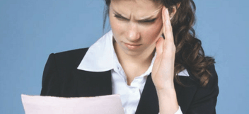 CPA looking over a document that apparently is giving her a headache