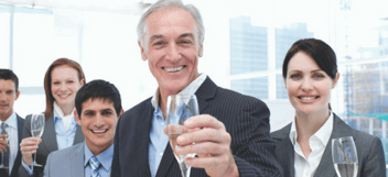 Business team celebrating with glasses of champagne.