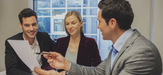 CPA talking taxes with a young couple