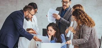 CPA surrounded by demanding coworkers during tax season