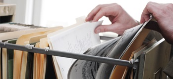 Someone looking through file cabinet records