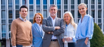 Business owner standing with a group of valued employees
