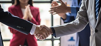 Private equity investor shaking hands with CPA firm owner