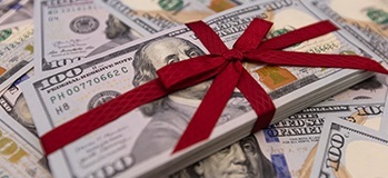 Stack of $100 bills wrapped in a bow