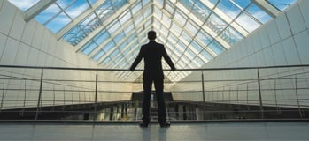 Executive looking out over a balcony guard rail